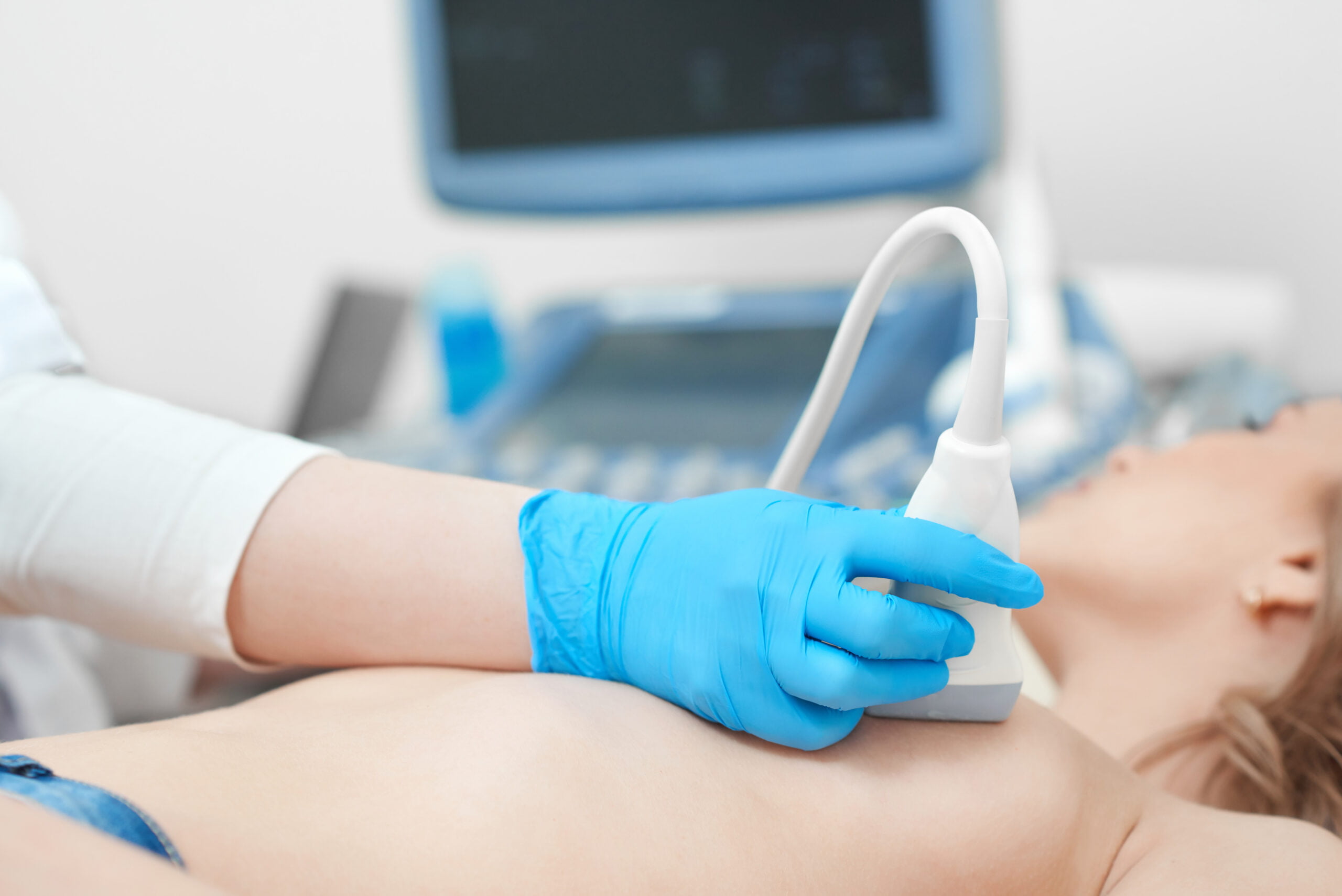 Young woman getting breast ultrasound scanning